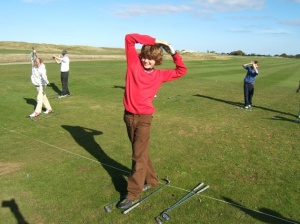 young golfer exercising balance during golf lesson